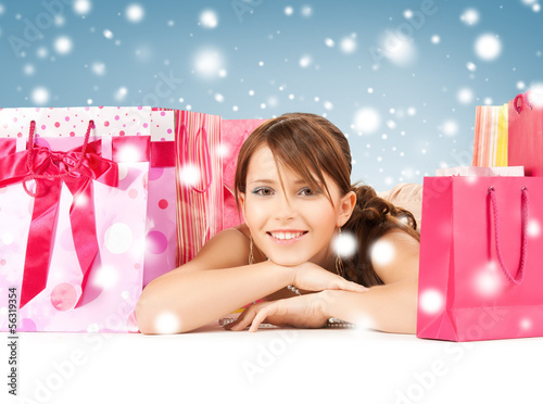 Photo: happy girl with shopping or gift bags happy girl with shopping or gift bags