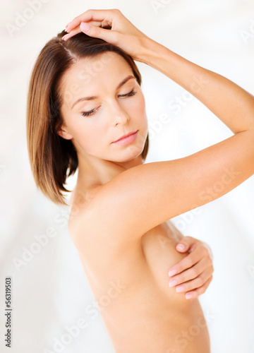 Photo: woman checking breast for signs of cancer woman checking breast for signs of cancer
