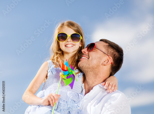 Photo: happy father and child in sunglasses over blue sky happy father and child in sunglasses over blue sky