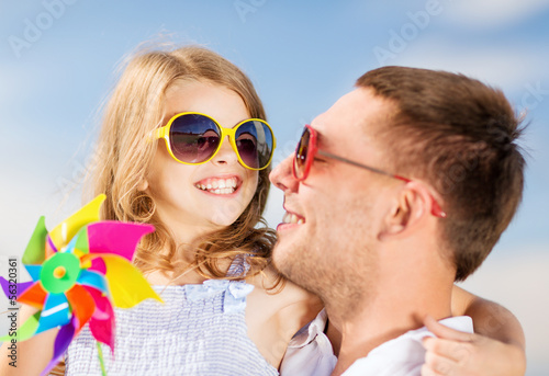 Photo: happy father and child in sunglasses over blue sky happy father and child in sunglasses over blue sky
