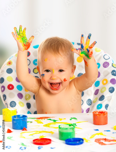 Photo: happy child draws with colored paints hands happy child draws with colored paints hands