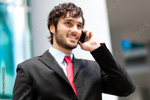 Photo: Handsome businessman talking on the cellphone Handsome businessman talking on the cellphone
