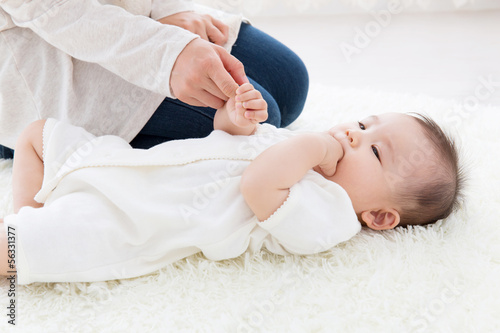 Photo: asian baby on the white carpet asian baby on the white carpet