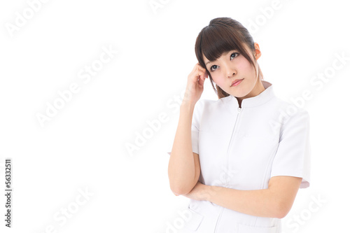 Photo: young asian nurse thinking on white background young asian nurse thinking on white background
