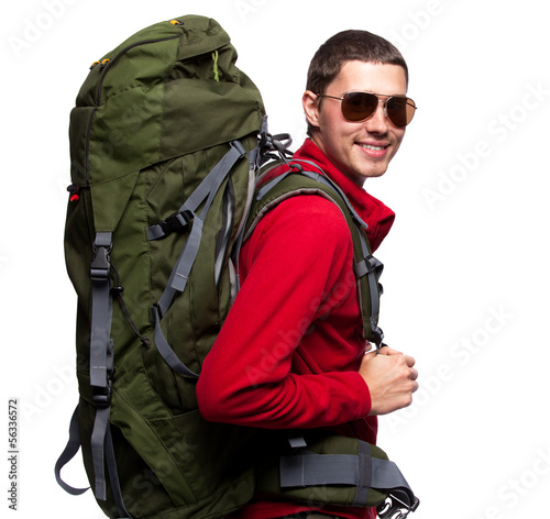 Photo: Hiker with backpack standing at white background Hiker with backpack standing at white background