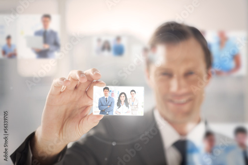 Photo: Happy businessman picking a picture Happy businessman picking a picture