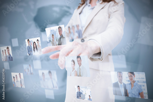 Photo: Stylish businesswoman presenting coworkers pictures Stylish businesswoman presenting coworkers pictures