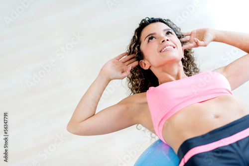 Photo: Gym woman doing crunches Gym woman doing crunches