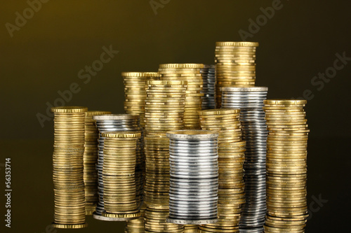 Photo: Many coins in columns on dark background Many coins in columns on dark background
