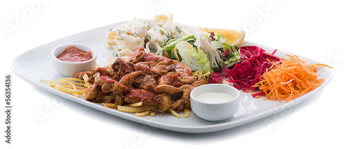 Photo: Chicken saute with salad and pasta on the side isolated Chicken saute with salad and pasta on the side isolated