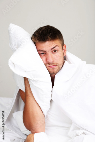 Photo: Handsome young man cant sleep in bed Handsome young man cant sleep in bed