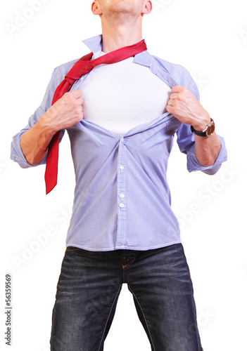 Photo: Superhero. Image of young man tearing his shirt off isolated on Superhero. Image of young man tearing his shirt off isolated on