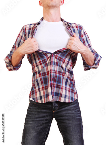 Photo: Superhero. Image of young man tearing his shirt off isolated on Superhero. Image of young man tearing his shirt off isolated on