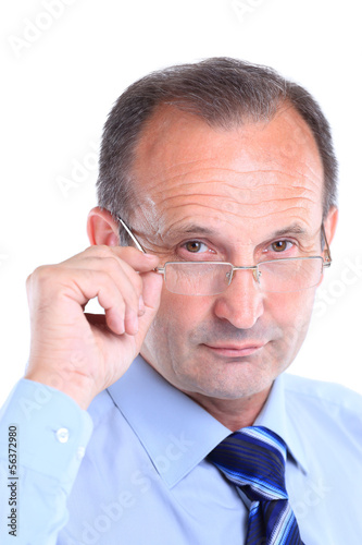 Photo: Portrait of a serious business man with glasses Portrait of a serious business man with glasses