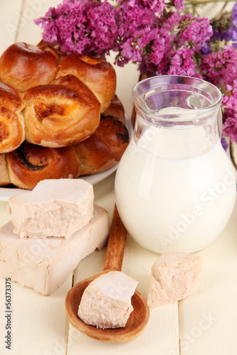 Photo: Dry yeast with pastry on wooden table close-up Dry yeast with pastry on wooden table close-up