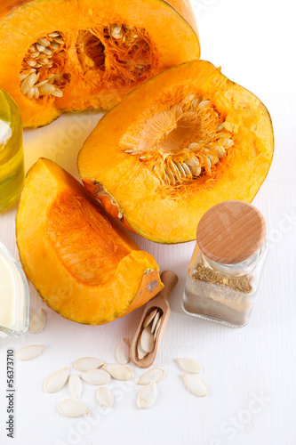 Photo: Cut pumpkin with ingredients for cooking isolated on white Cut pumpkin with ingredients for cooking isolated on white