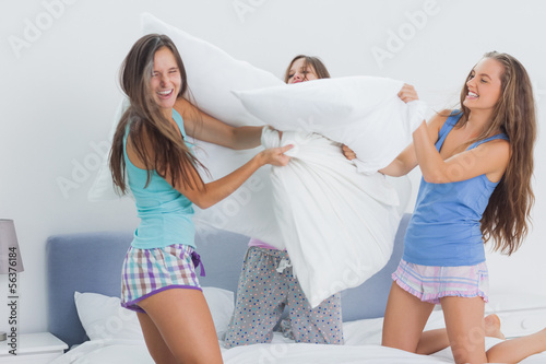 Photo: Friends having pillow fight Friends having pillow fight