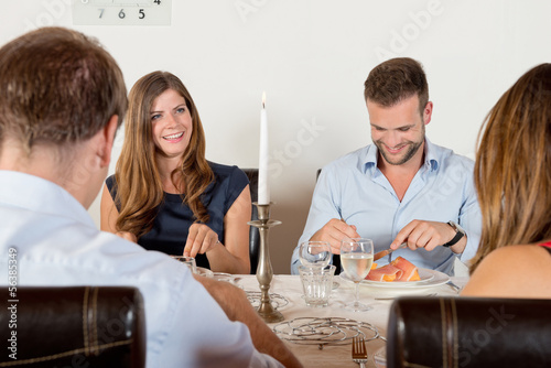Photo: Friends enjoying dinner at home Friends enjoying dinner at home