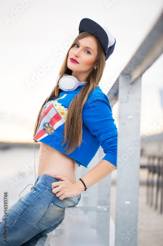 Photo: Stylish girl with long hair posing near river Stylish girl with long hair posing near river
