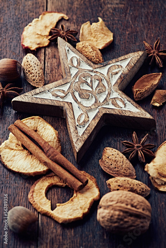 Photo: Wooden christmas star and ingredeints for a christmas cake Wooden christmas star and ingredeints for a christmas cake