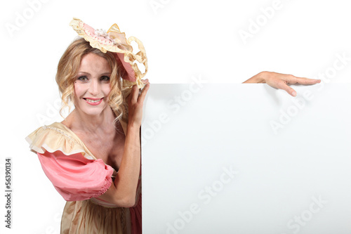 Photo: Blank advertising board and woman in fancy dress Blank advertising board and woman in fancy dress