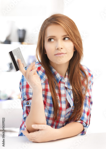 Photo: pensive teenage girl with credit card pensive teenage girl with credit card
