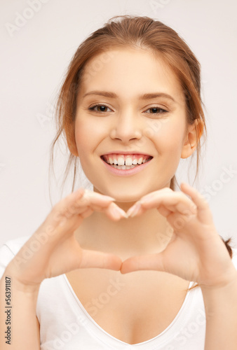 Photo: woman showing heart shape woman showing heart shape