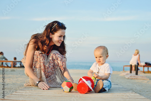 Photo: mother and baby son playing toys mother and baby son playing toys