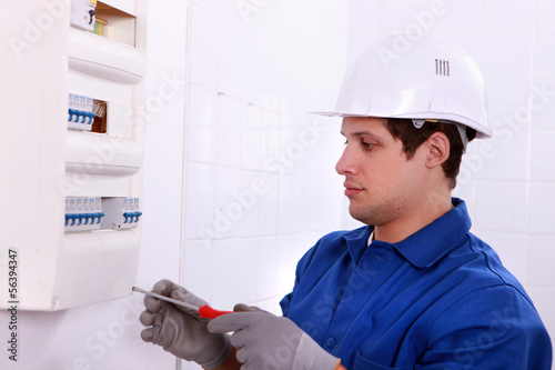 Photo: Electrician examining a fuse box Electrician examining a fuse box