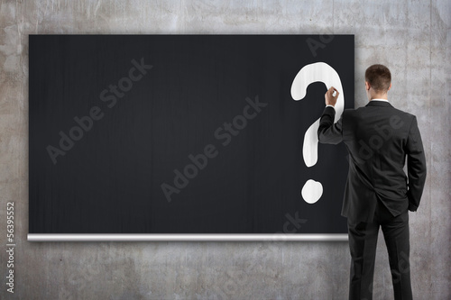Photo: businessman drawing question mark businessman drawing question mark