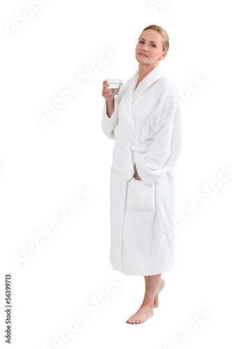 Photo: Woman in bath robe with a glass of water Woman in bath robe with a glass of water