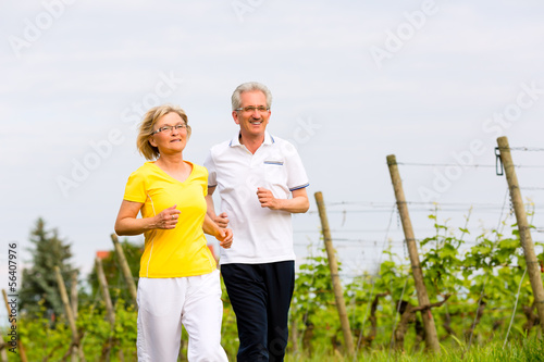 Photo: Seniors running in the nature doing sport Seniors running in the nature doing sport