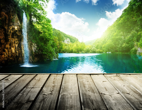 Photo: waterfall in deep forest of croatia and wood pier waterfall in deep forest of croatia and wood pier