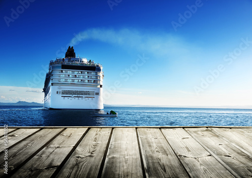 Photo: Caribbean sea and cruise ship and wood pier Caribbean sea and cruise ship and wood pier