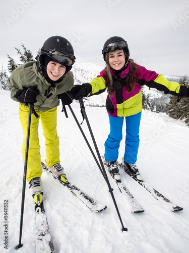 Photo: Teenage girl and boy skiing Teenage girl and boy skiing