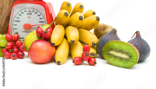 Photo: Fruit and kitchen scales on a white background Fruit and kitchen scales on a white background