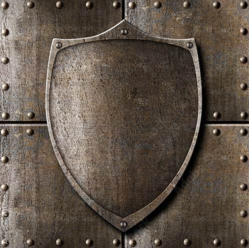 Photo: old metal shield over armour background with rivets old metal shield over armour background with rivets