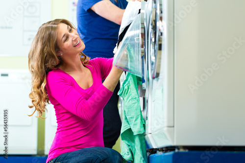 Photo: Students in a coin laundry washing Students in a coin laundry washing