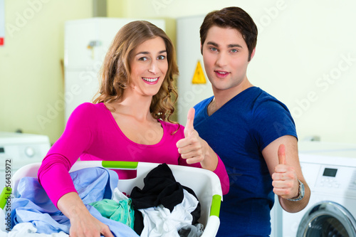 Photo: couple in a coin laundry washing couple in a coin laundry washing
