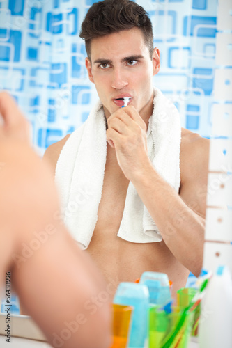 Photo: Young man brushing his teeth Young man brushing his teeth