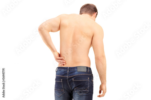 Photo: Man shot from behind suffering a back pain Man shot from behind suffering a back pain