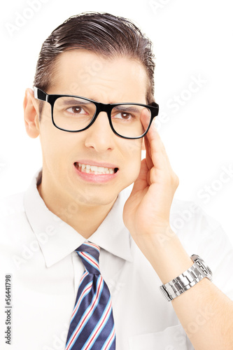 Photo: Portrait of a young man having a toothache Portrait of a young man having a toothache