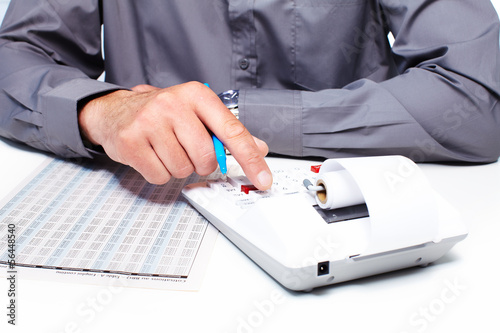 Photo: Hand of a businessman with calculator. Hand of a businessman with calculator.