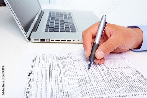 Photo: Businessman filling the form. Businessman filling the form.