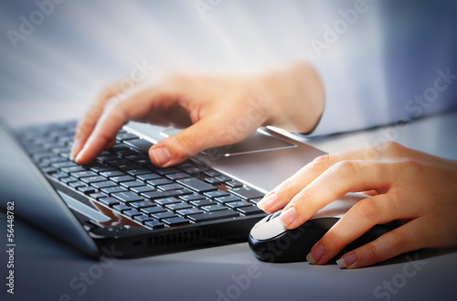 Photo: Hands with laptop computer keyboard. Hands with laptop computer keyboard.