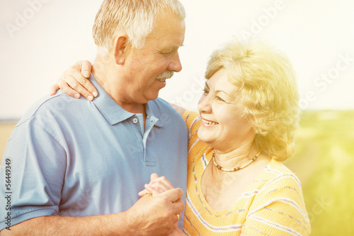 Photo: Old people over field background Old people over field background