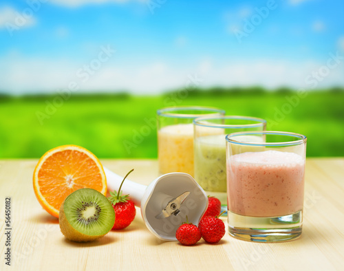 Photo: Fruit smoothie on wooden table on rural background Fruit smoothie on wooden table on rural background