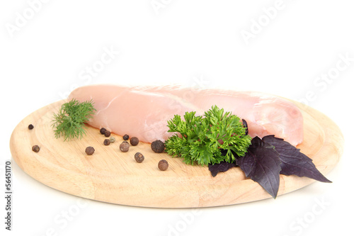 Photo: Raw chicken fillets on wooden board, isolated on white Raw chicken fillets on wooden board, isolated on white