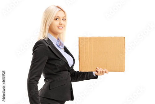 Photo: Blond woman in suit holding a piece of cardboard Blond woman in suit holding a piece of cardboard