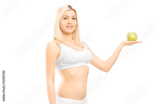 Photo: Young beautiful woman in white cotton underwear holding apple Young beautiful woman in white cotton underwear holding apple
